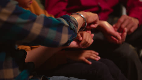 Close-Up-Of-Multi-Generation-Male-Sikh-Family-Wearing-And-Discussing-Traditional-Silver-Bangles-Or-Bracelets-Sitting-On-Sofa-At-Home-Shot-In-Real-Time-1